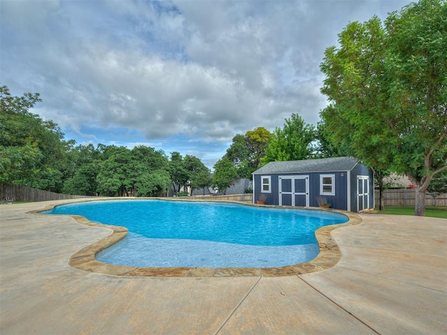 1233 Autumn Creek Dr, Edmond, OK 73003 - view of swimming pool featuring a fenced backyard, a patio area, and a storage shed