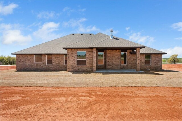 2344 Knox Ln, Blanchard, OK 73010 - back of house featuring roof with shingles, a patio, and brick siding