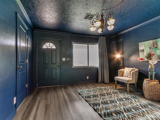 1710 Carlisle Rd, Oklahoma City, OK 73120 - entryway with crown molding, wood finished floors, a chandelier, and a textured wall