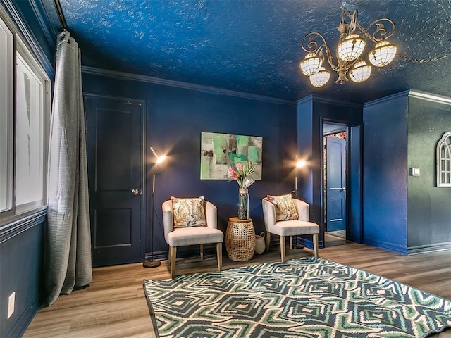 1710 Carlisle Rd, Oklahoma City, OK 73120 - living area featuring wood finished floors, a chandelier, and crown molding