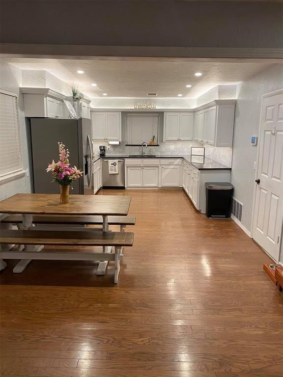 1717 S Webster Dr, Midwest City, OK 73130 - dining space with light wood finished floors and recessed lighting