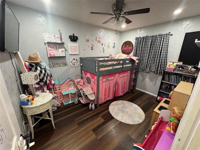 1717 S Webster Dr, Midwest City, OK 73130 - bedroom with wood finished floors, a textured wall, and ceiling fan