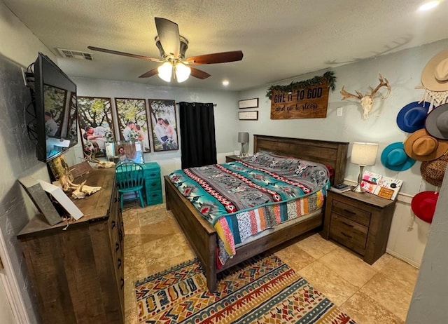 1717 S Webster Dr, Midwest City, OK 73130 - bedroom featuring ceiling fan and a textured ceiling