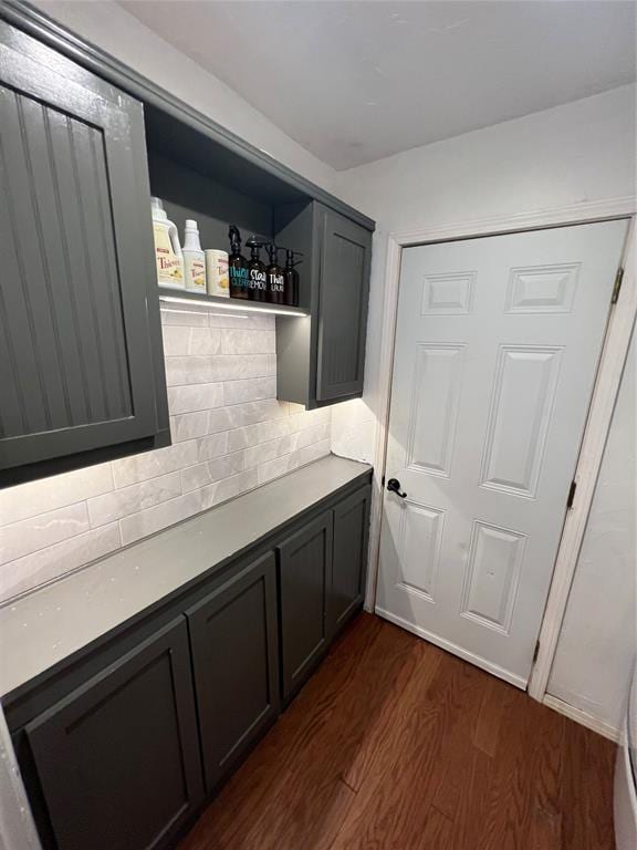 1717 S Webster Dr, Midwest City, OK 73130 - bar area with dark wood finished floors and tasteful backsplash