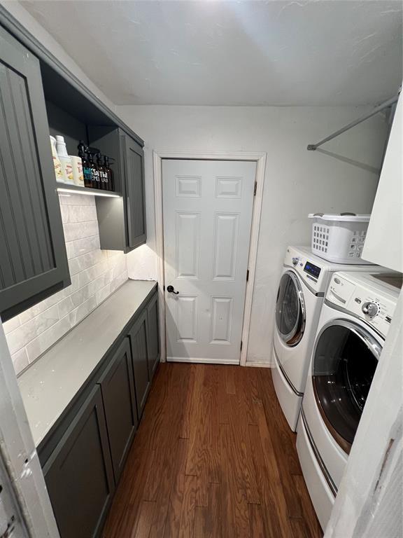 1717 S Webster Dr, Midwest City, OK 73130 - laundry room featuring cabinet space, independent washer and dryer, and dark wood-style floors