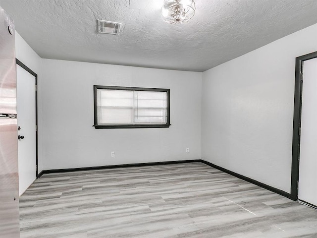 3225 SE 20th St, Oklahoma City, OK 73115 - unfurnished room with wood finished floors and a textured ceiling