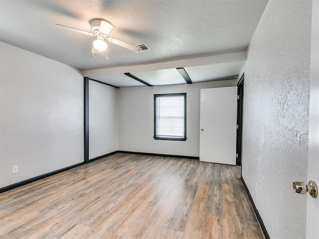 3225 SE 20th St, Oklahoma City, OK 73115 - unfurnished room featuring wood finished floors, a textured wall, and ceiling fan