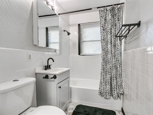 3225 SE 20th St, Oklahoma City, OK 73115 - full bath with tile walls, vanity, shower / bathtub combination with curtain, and a textured wall