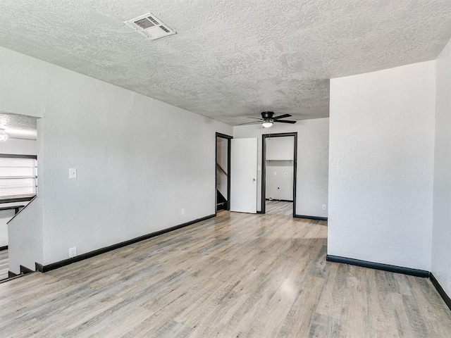 3225 SE 20th St, Oklahoma City, OK 73115 - unfurnished room featuring wood finished floors, ceiling fan, a textured ceiling, and stairs