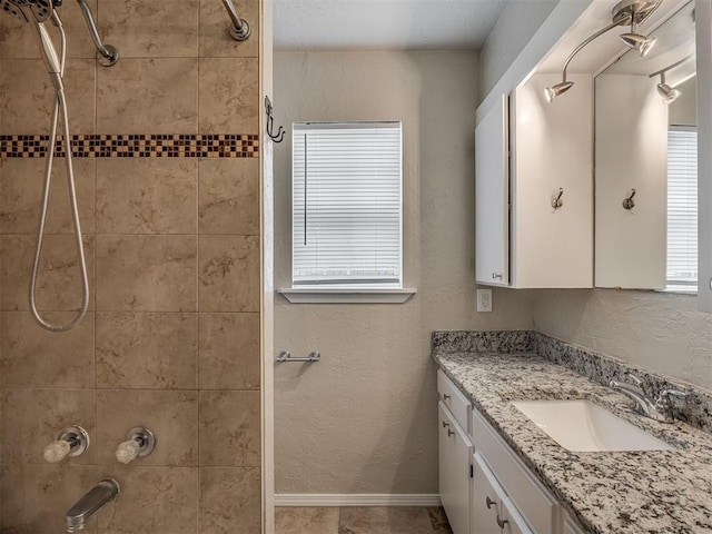 201 N Base Ave, Norman, OK 73069 - bathroom featuring vanity, tiled shower, and plenty of natural light
