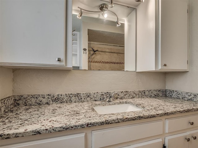 201 N Base Ave, Norman, OK 73069 - full bath featuring vanity, a textured wall, and a shower