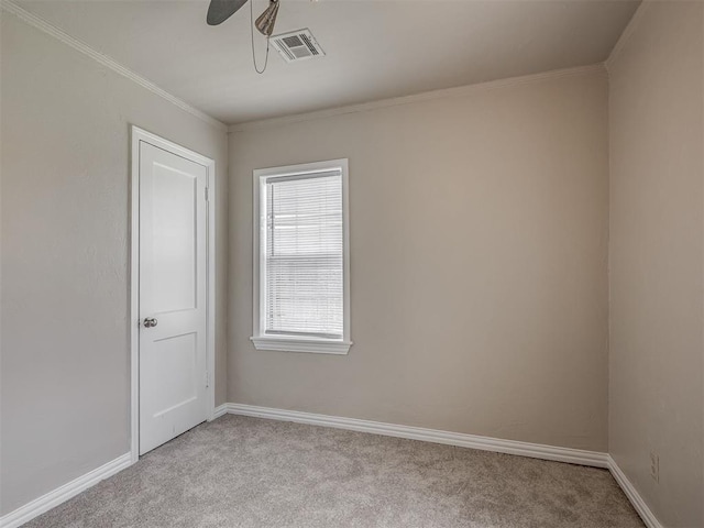 201 N Base Ave, Norman, OK 73069 - spare room featuring light carpet, crown molding, and ceiling fan