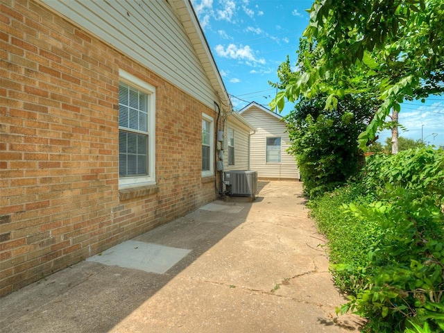 201 N Base Ave, Norman, OK 73069 - view of side of property featuring a patio and brick siding