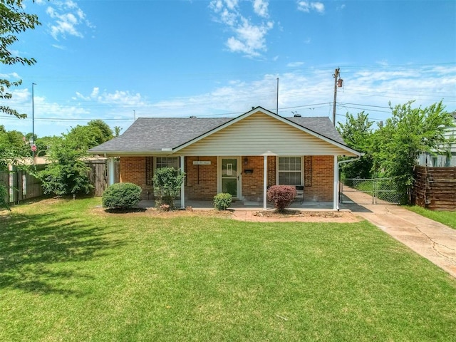 201 N Base Ave, Norman, OK 73069 - view of front facade featuring driveway, covered porch, brick siding, and a shingled roof