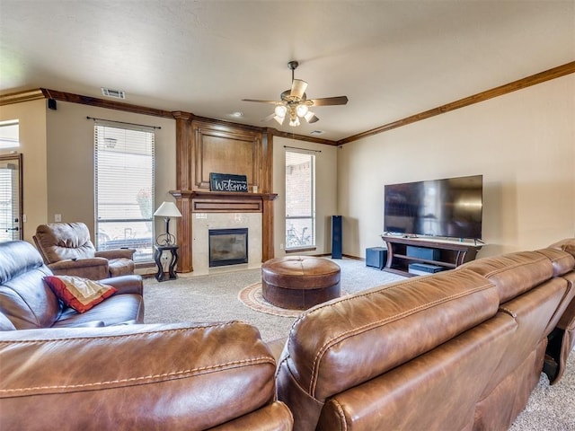 1621 NW 182nd St, Edmond, OK 73012 - carpeted living area with crown molding, a ceiling fan, plenty of natural light, and a high end fireplace