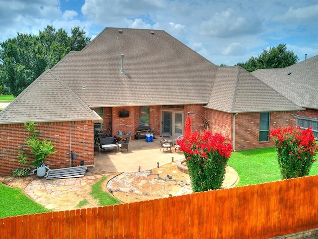 1621 NW 182nd St, Edmond, OK 73012 - rear view of house with roof with shingles, brick siding, and a patio area