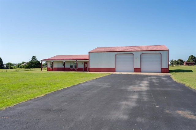 27919 Tortola Ln, Blanchard, OK 73010 - view of front facade with a detached garage, a front yard, and a metal roof