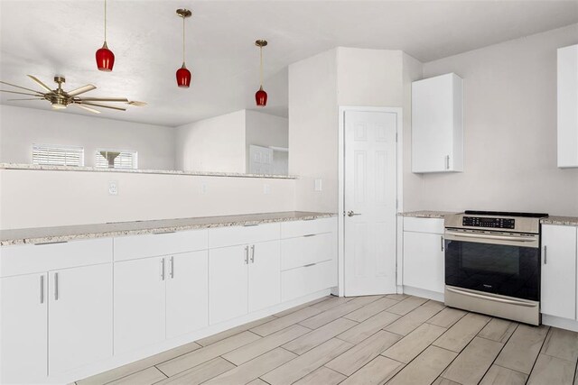 27919 Tortola Ln, Blanchard, OK 73010 - kitchen with stainless steel electric range, a ceiling fan, white cabinets, pendant lighting, and wood tiled floors