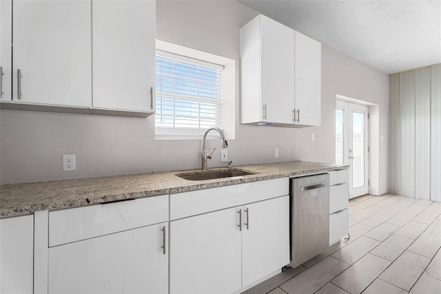 27919 Tortola Ln, Blanchard, OK 73010 - kitchen featuring stainless steel dishwasher, white cabinetry, and light stone counters