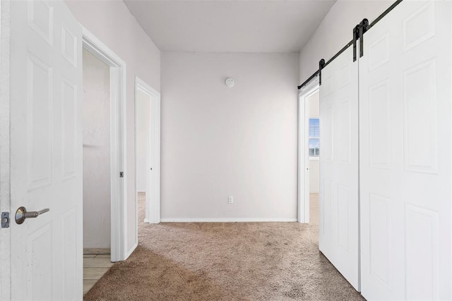27919 Tortola Ln, Blanchard, OK 73010 - hallway featuring a barn door and light carpet