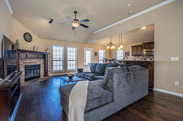 1613 NW 124th St, Oklahoma City, OK 73120 - living area featuring a fireplace, dark wood-style floors, vaulted ceiling, ceiling fan, and a chandelier