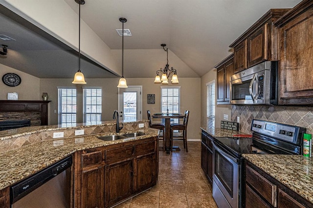 1613 NW 124th St, Oklahoma City, OK 73120 - kitchen with appliances with stainless steel finishes, vaulted ceiling, tasteful backsplash, stone counters, and tile patterned flooring