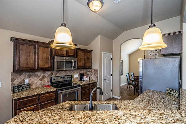 1613 NW 124th St, Oklahoma City, OK 73120 - kitchen featuring stainless steel appliances, vaulted ceiling, dark brown cabinets, light stone counters, and tasteful backsplash