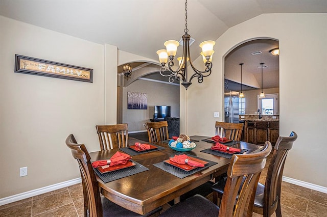 1613 NW 124th St, Oklahoma City, OK 73120 - dining space with arched walkways, a chandelier, and vaulted ceiling