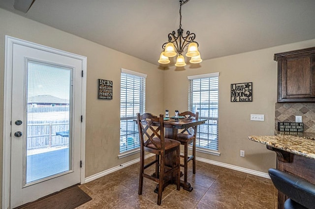 1613 NW 124th St, Oklahoma City, OK 73120 - dining area featuring a chandelier and dark tile patterned flooring