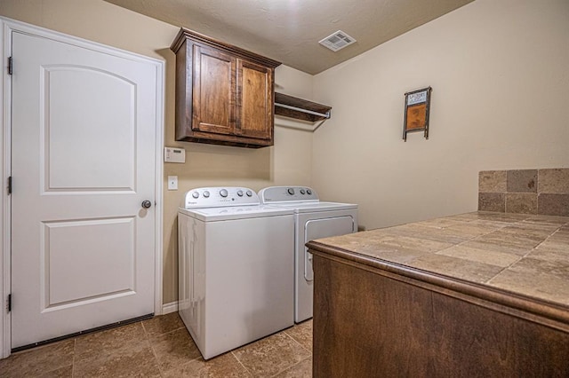 1613 NW 124th St, Oklahoma City, OK 73120 - laundry area with cabinet space and washing machine and clothes dryer