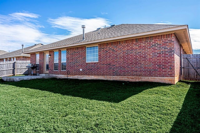1613 NW 124th St, Oklahoma City, OK 73120 - back of property with a fenced backyard, brick siding, a shingled roof, and a patio area