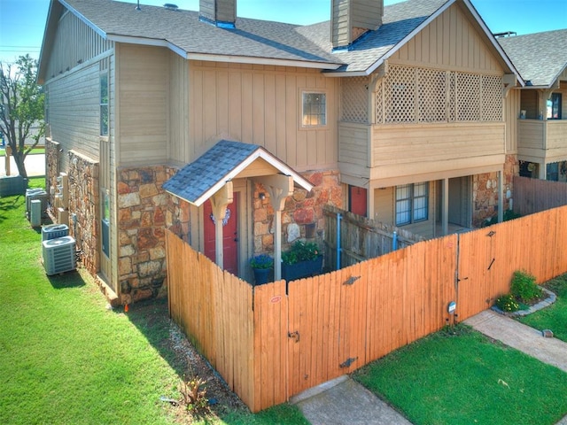 14313 N Pennsylvania Ave Unit 7E, Oklahoma City, OK 73134 - view of front of property featuring a chimney, stone siding, and roof with shingles