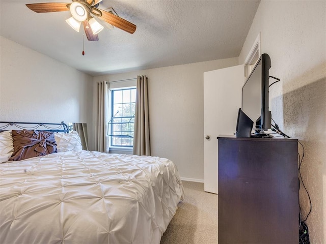 14313 N Pennsylvania Ave Unit 7E, Oklahoma City, OK 73134 - bedroom featuring light carpet, a ceiling fan, and a textured ceiling