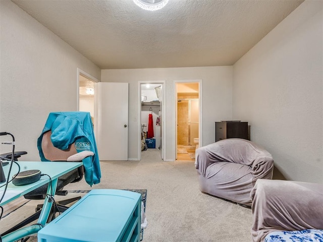14313 N Pennsylvania Ave Unit 7E, Oklahoma City, OK 73134 - carpeted bedroom featuring a spacious closet, connected bathroom, and a textured ceiling
