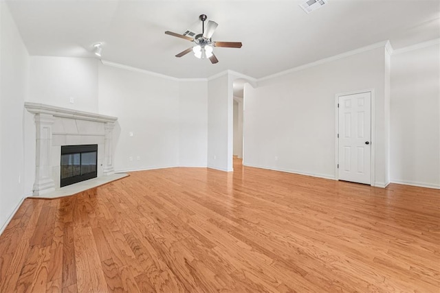 9716 SW 21st Ter, Oklahoma City, OK 73128 - unfurnished living room with ceiling fan, ornamental molding, light wood finished floors, and a tiled fireplace