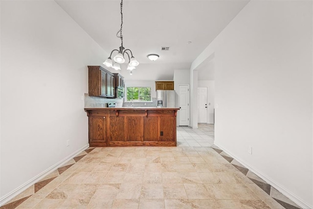 9716 SW 21st Ter, Oklahoma City, OK 73128 - kitchen with appliances with stainless steel finishes, a peninsula, a chandelier, and pendant lighting