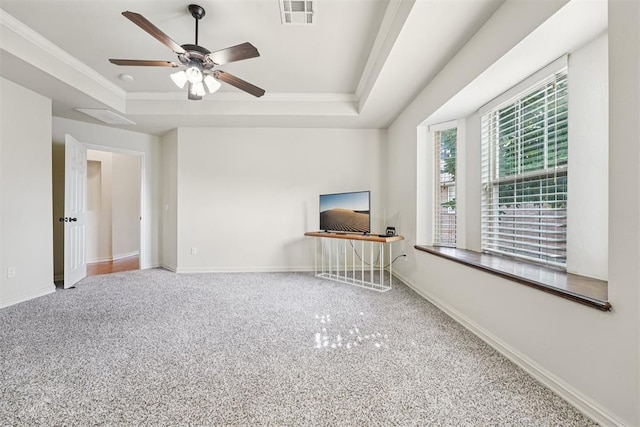 9716 SW 21st Ter, Oklahoma City, OK 73128 - unfurnished living room featuring a tray ceiling, a ceiling fan, carpet, ornamental molding, and an office area