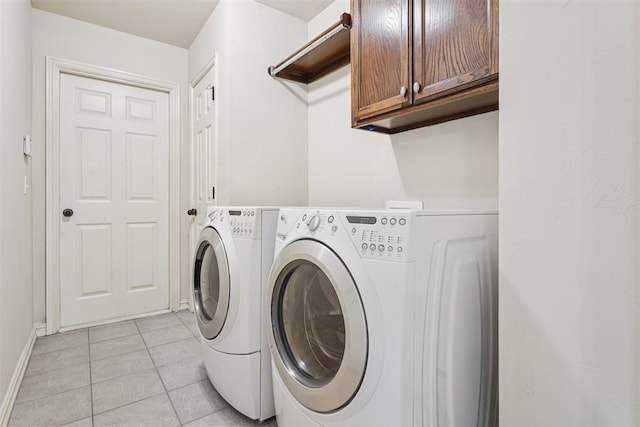 9716 SW 21st Ter, Oklahoma City, OK 73128 - washroom featuring cabinet space, washing machine and dryer, and light tile patterned flooring
