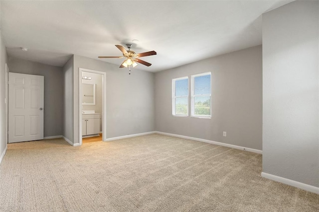 3919 SE 10th Pl, Oklahoma City, OK 73115 - unfurnished bedroom with light carpet, connected bathroom, and ceiling fan