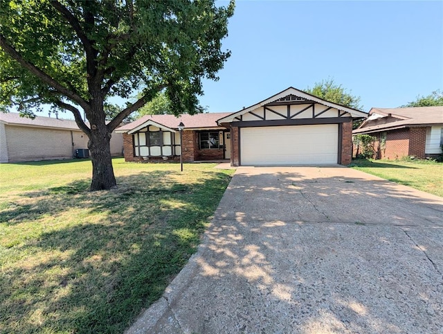 104 SW 10th St, Moore, OK 73160 - view of front of home with concrete driveway, a garage, brick siding, and a front lawn