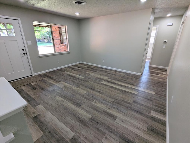 104 SW 10th St, Moore, OK 73160 - entrance foyer featuring a textured ceiling and wood finished floors