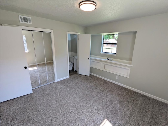 104 SW 10th St, Moore, OK 73160 - unfurnished bedroom featuring carpet, a textured ceiling, and a closet