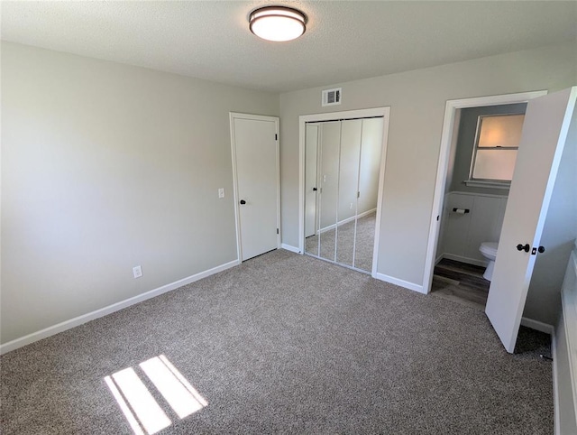 104 SW 10th St, Moore, OK 73160 - unfurnished bedroom with carpet, a closet, ensuite bathroom, and a textured ceiling