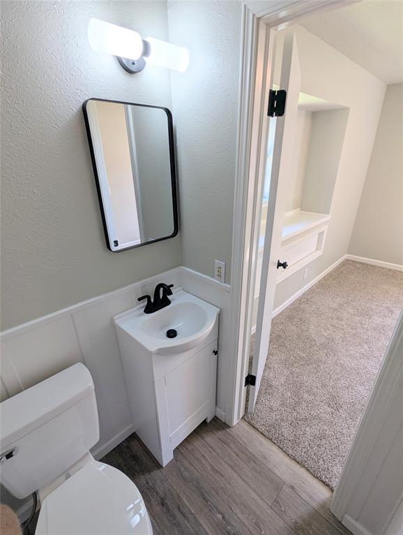 104 SW 10th St, Moore, OK 73160 - half bath with vanity and wood finished floors