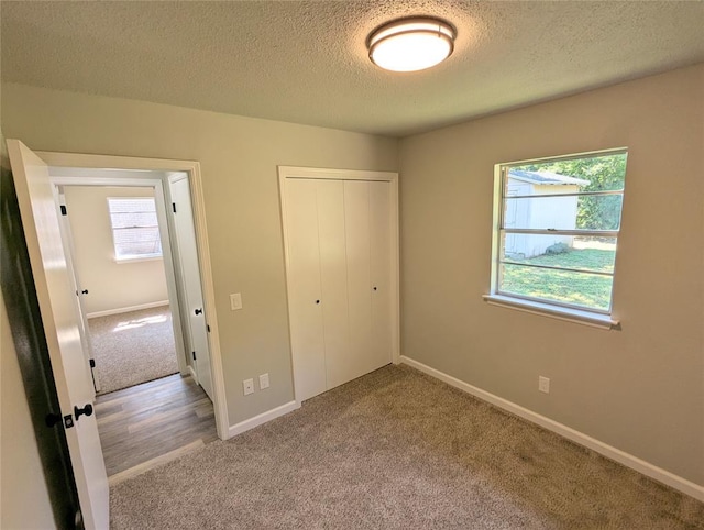 104 SW 10th St, Moore, OK 73160 - unfurnished bedroom featuring carpet flooring, a closet, and a textured ceiling