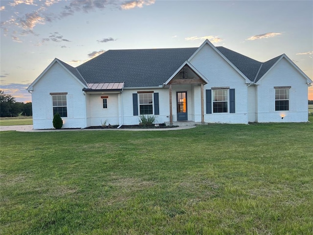 17566 N County Road 3190, Pauls Valley, OK 73075 - modern farmhouse with a standing seam roof, a lawn, a metal roof, and brick siding