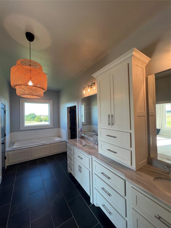 17566 N County Road 3190, Pauls Valley, OK 73075 - full bathroom featuring double vanity, a bath, tile patterned flooring, and plenty of natural light
