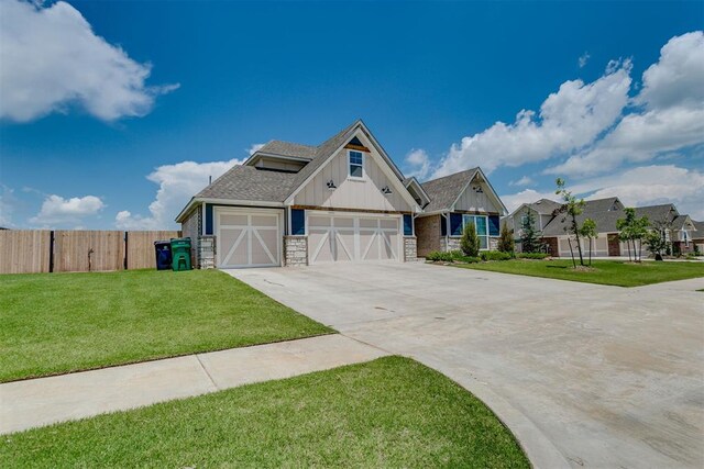 10125 NW 99th St, Yukon, OK 73099 - view of front facade featuring board and batten siding, concrete driveway, stone siding, an attached garage, and a shingled roof