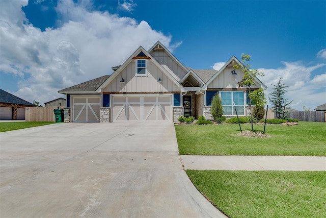 10125 NW 99th St, Yukon, OK 73099 - craftsman-style house with board and batten siding, stone siding, driveway, and an attached garage