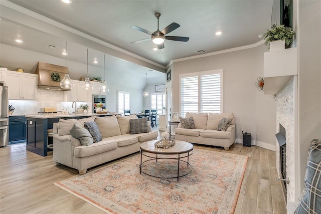 10125 NW 99th St, Yukon, OK 73099 - living area featuring a ceiling fan, ornamental molding, light wood-style floors, a fireplace, and recessed lighting